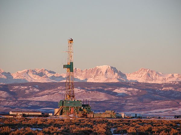 Energy development is economically important for Wyoming and the nation. Unfortunately, much development occurs in previously intact habitats that are important for wildlife, including many species listed as Species of Greatest Conservation Need by the Wyoming Game and Fish Department. (Photo: Stewart Point Rig, 2003, L. Baker. Courtesy of Wyoming Outdoor Council.)