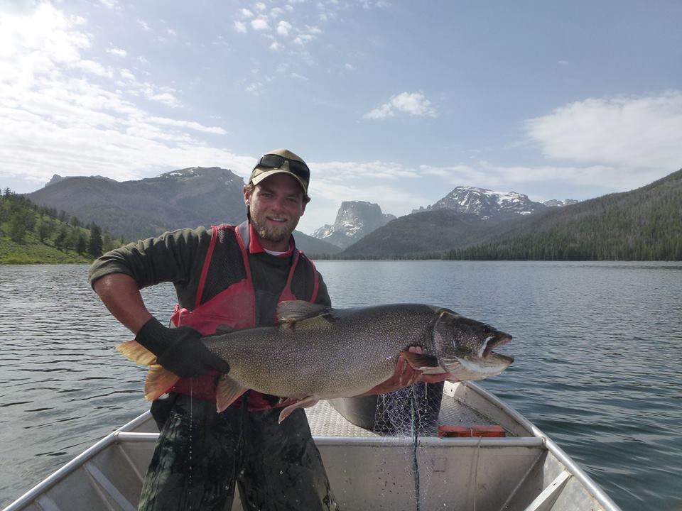 Alex LeCheminant with lake trout caught while conducting anual lake surveys with Wyoming Game and Fish Dept.