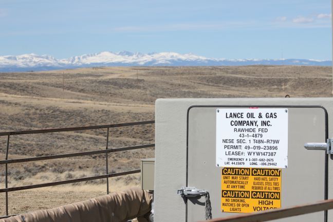 A federally permitted coal-bed methane well in the Powder River Basin (with the Bighorn Mountains in the background)