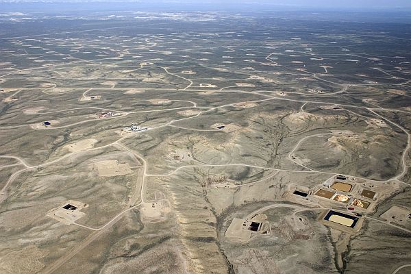 Though the land area actually falling under well pads and roads is only a small percentage of total surface area, these features introduce human activity and fragment formerly contiguous habitat. When considered at the landscape scale, the footprint of energy development is potentially extensive. (Photo: Jona Field near Pinedale, Wyoming by J. Vanuga. Courtesy of Wyoming Outdoor Council)